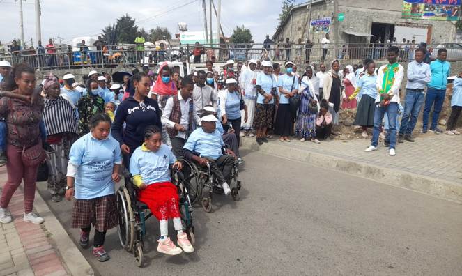 Marchers hold up placards at a disability rights demonstration.